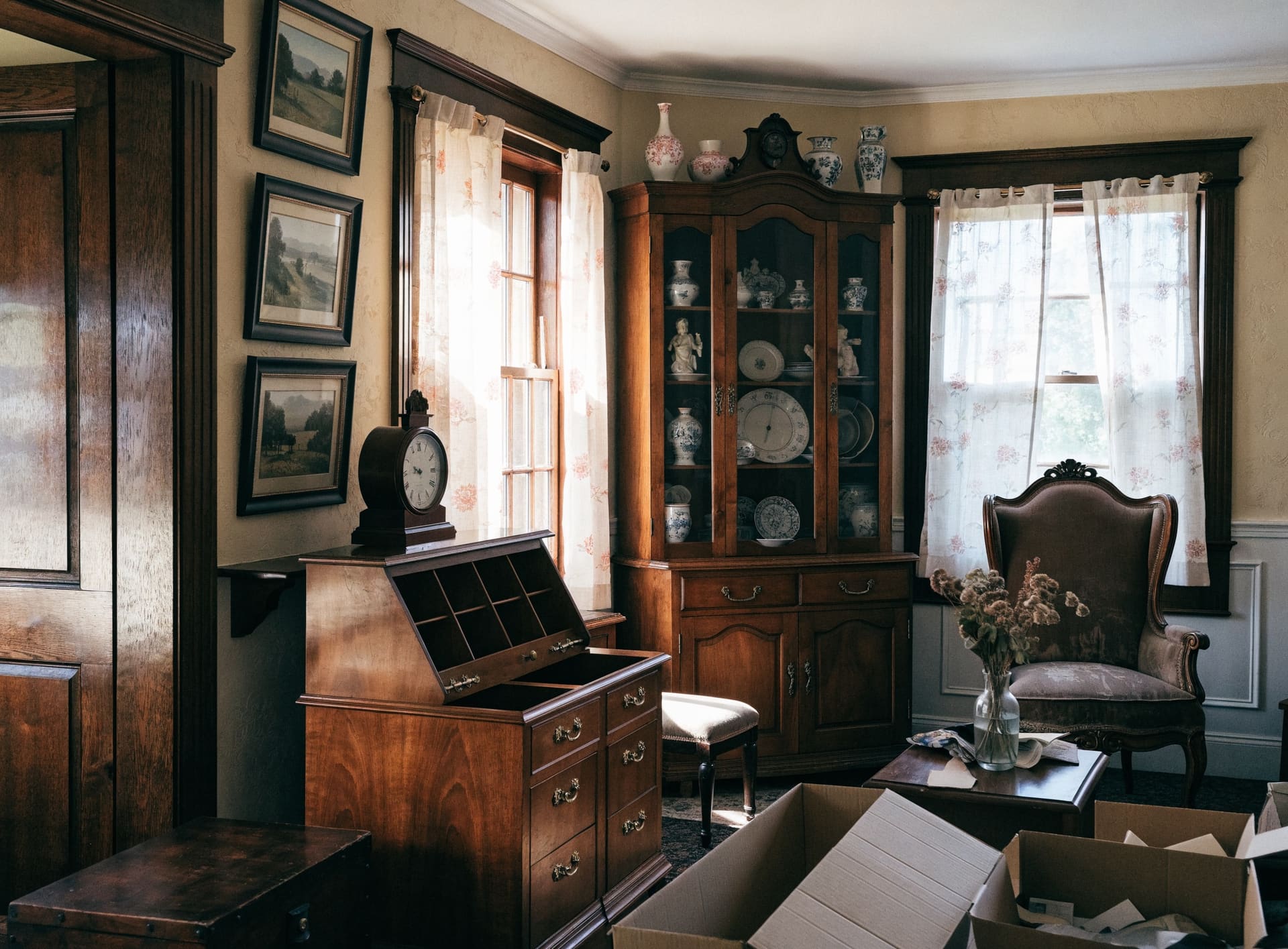Representative photograph: antique furniture, paintings and a china cabinet in an older home