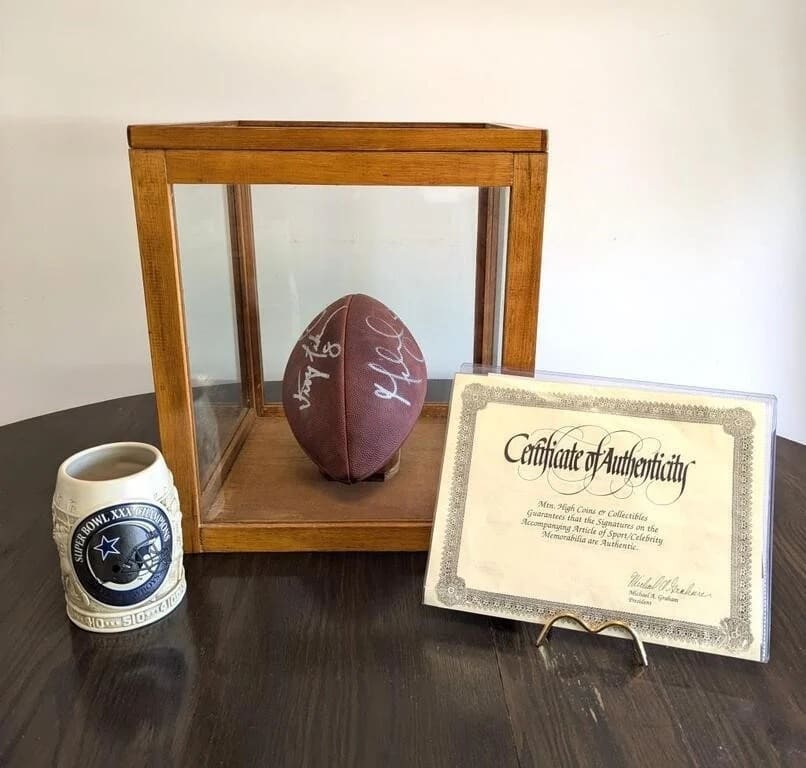 Signed football in a display case with a certificate of authenticity
